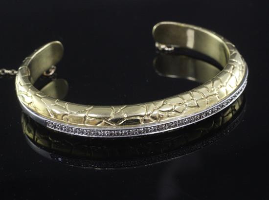 A 1980s Italian Gucci 18ct gold and diamond set crocodillo open bangle,